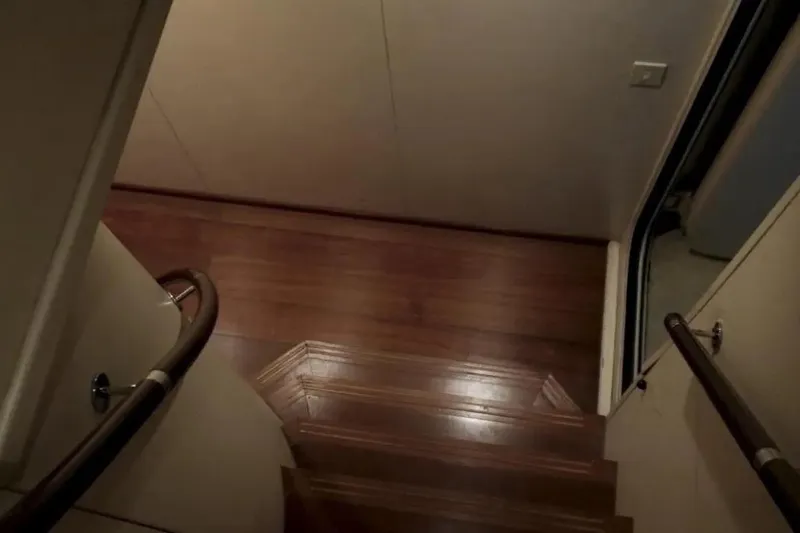 Yacht Photos Pics Staircase with wooden steps inside a 1987 Lurssen 110 yacht.