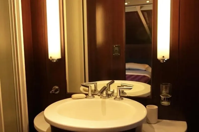  Yacht Photos Pics Luxurious bathroom interior of 1987 Lurssen 110 yacht with elegant fixtures and lighting.