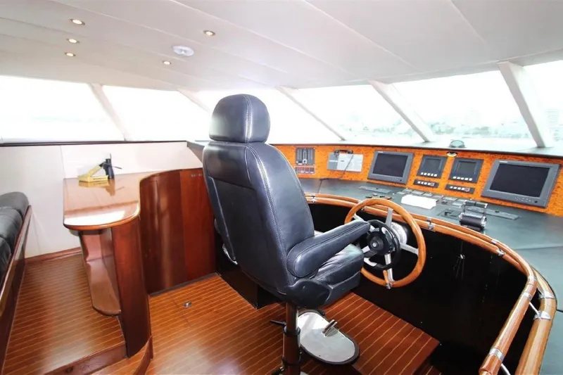  Yacht Photos Pics Luxurious 1987 Lurssen 110 yacht helm with leather chair and advanced navigation controls.