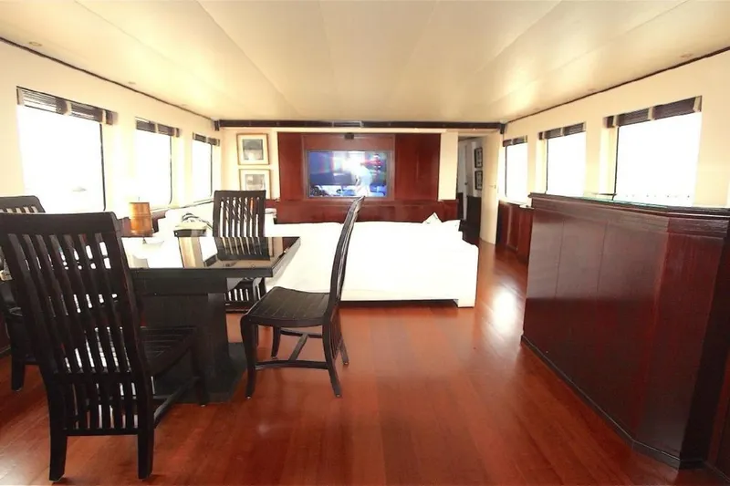  Yacht Photos Pics Luxurious interior of 1987 Lurssen 110 yacht with elegant wood furnishings and ample seating.