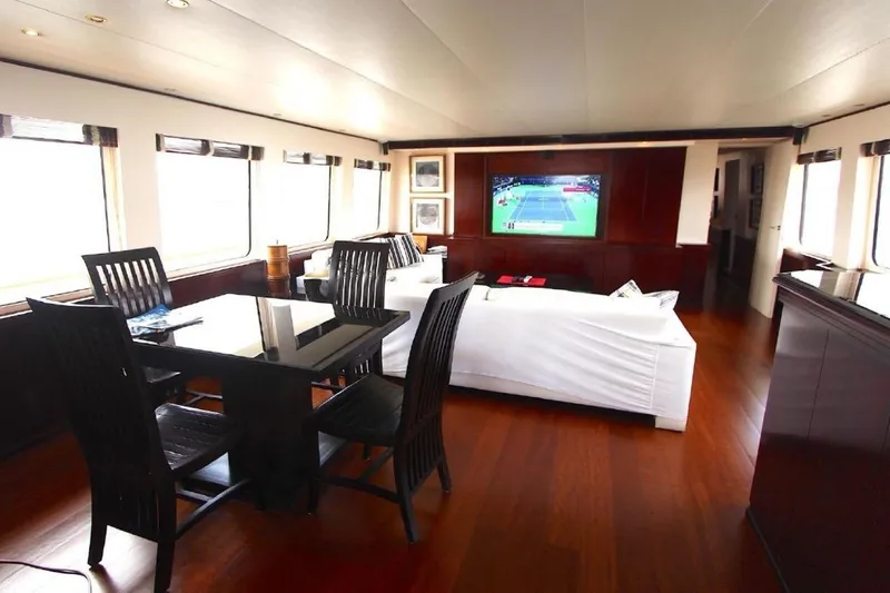  Yacht Photos Pics Luxurious interior of 1987 Lurssen 110 yacht with elegant dining and entertainment area.