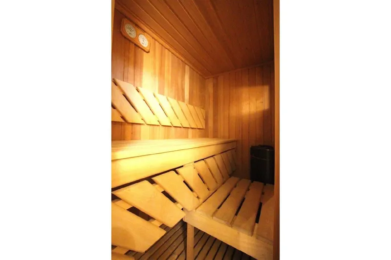  Yacht Photos Pics Wooden sauna interior on 1987 Lurssen 110 yacht, featuring benches and temperature gauges.