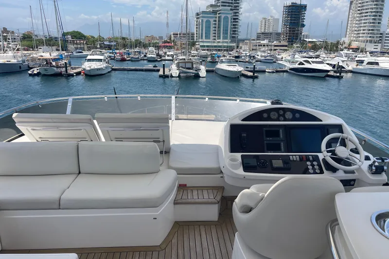 Sea C Yacht Photos Pics Luxurious 2012 Sunseeker 73 yacht interior with marina view, featuring plush seating and modern controls.