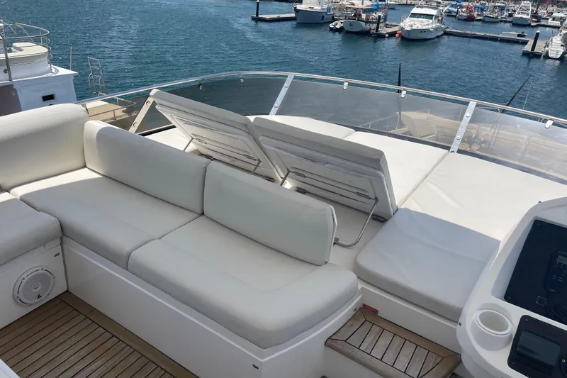 Sea C Yacht Photos Pics Luxurious Sunseeker 73 yacht deck with white seating, overlooking marina, 2012 model.
