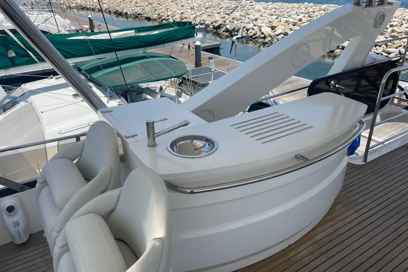Sea C Yacht Photos Pics Luxurious 2012 Sunseeker 73 yacht deck with seating and bar area.