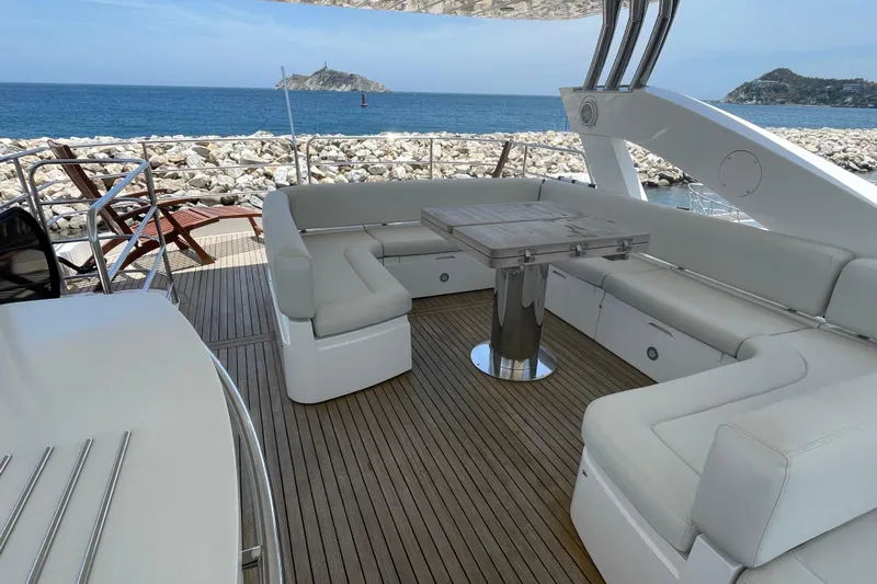 Sea C Yacht Photos Pics Luxurious Sunseeker 73 yacht deck with seating, table, and ocean view, 2012 model.