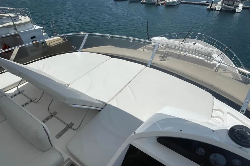 Sea C Yacht Photos Pics Sunseeker 73 yacht (2012) with sunbathing deck, docked at marina.