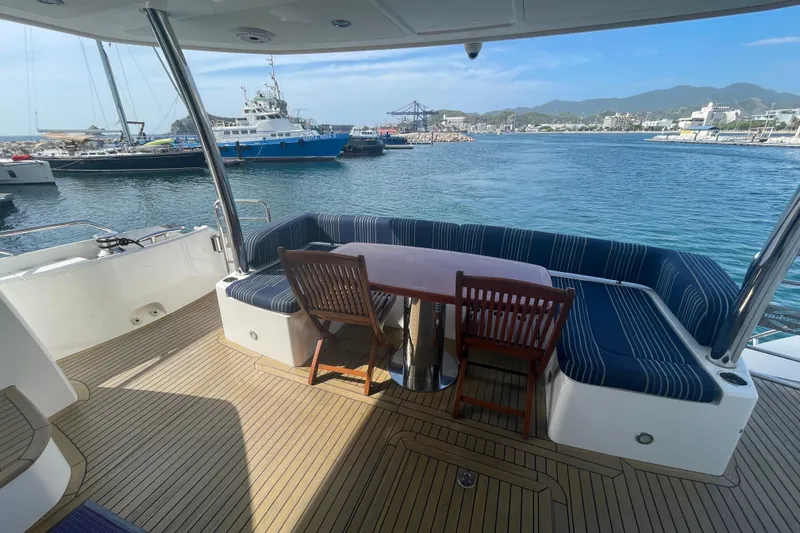 Sea C Yacht Photos Pics Luxury Sunseeker 73 yacht deck with seating, overlooking marina and mountains, 2012 model.