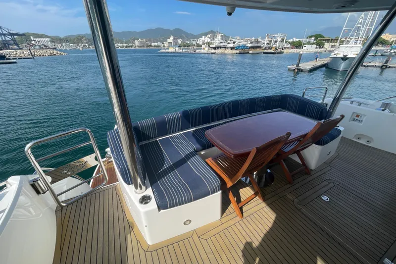 Sea C Yacht Photos Pics Luxury Sunseeker 73 yacht deck with seating, table, and marina view, 2012 model.