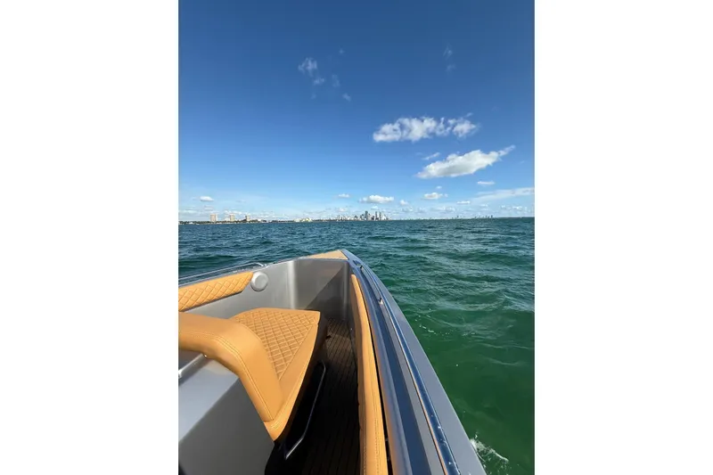 Iguana Sport Exclusive Yacht Photos Pics 2025 Iguana Yacht Sport Exclusive cruising on open water under clear blue sky.