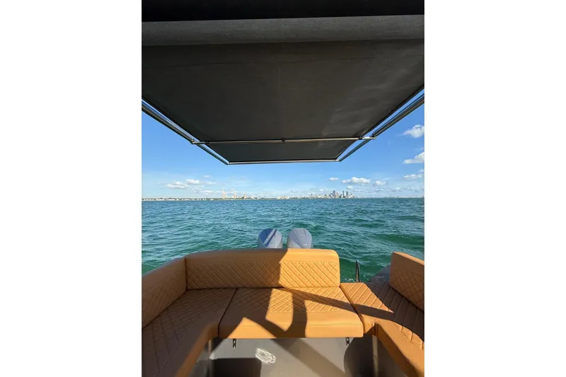 Iguana Sport Exclusive Yacht Photos Pics Luxury Iguana Yacht Sport Exclusive 2025 on open water with city skyline view.