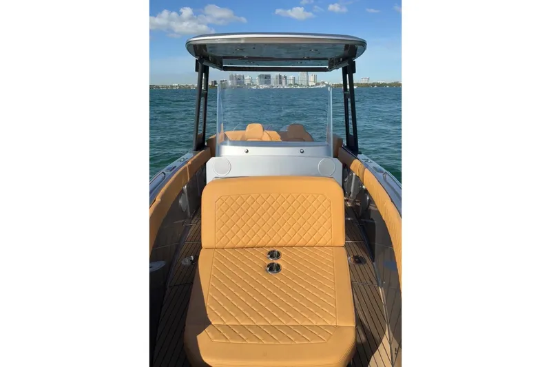 Iguana Sport Exclusive Yacht Photos Pics 2025 Iguana Yacht Sport Exclusive on water, featuring luxurious tan seating and sleek design.