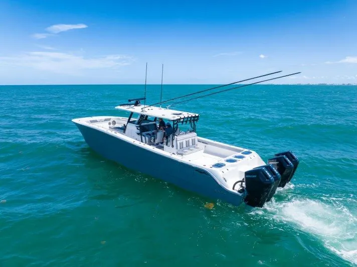  Yacht Photos Pics 2025 Invincible 46 Catamaran cruising on open ocean under clear blue sky.