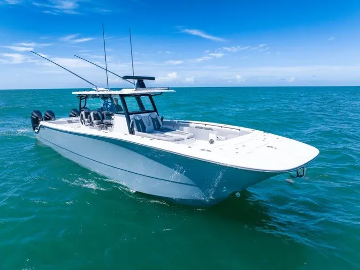  Yacht Photos Pics 2025 Invincible 46 Catamaran cruising on open ocean under clear blue sky.