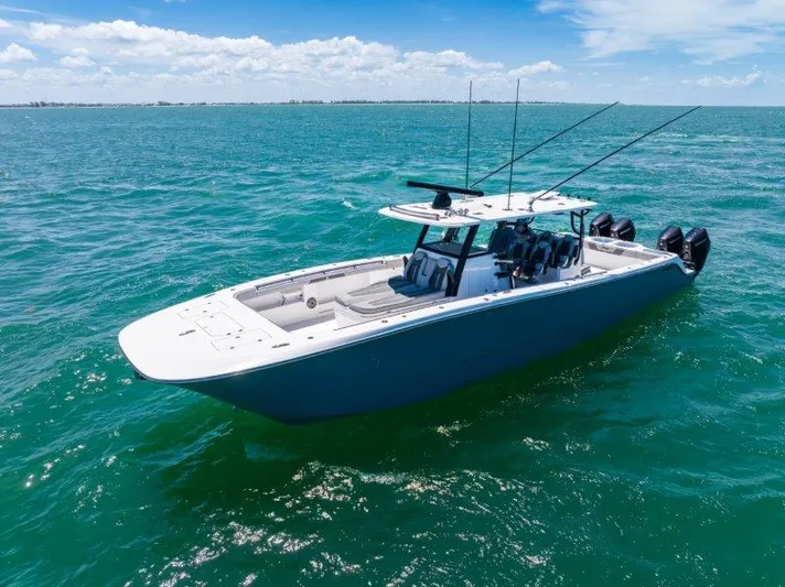  Yacht Photos Pics 2025 Invincible 46 Catamaran on open sea, clear skies, and calm waters.