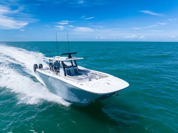  Yacht Photos Pics 2025 Invincible 46 Catamaran cruising on open ocean under clear blue sky.