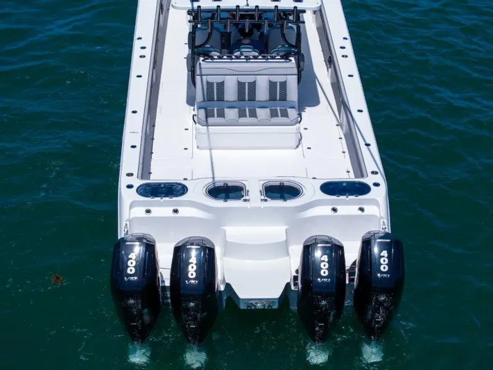  Yacht Photos Pics 2025 Invincible 46 Catamaran with four powerful outboard engines on the water.