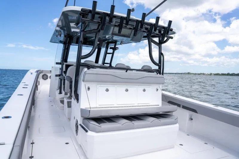  Yacht Photos Pics 2025 Invincible 46 Catamaran on open water, featuring sleek seating and rod holders.