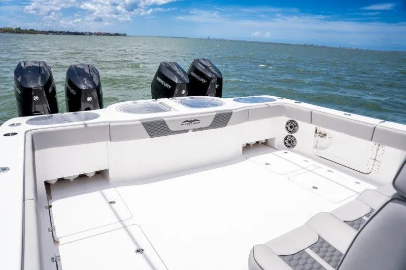  Yacht Photos Pics 2025 Invincible 46 Catamaran with powerful outboard motors on open water.