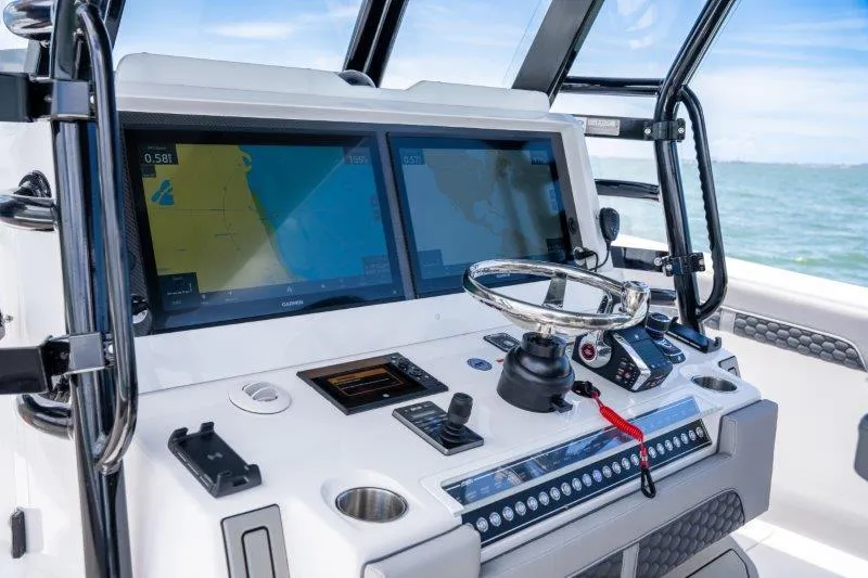  Yacht Photos Pics Helm of 2025 Invincible 46 Catamaran with dual navigation screens and modern controls.