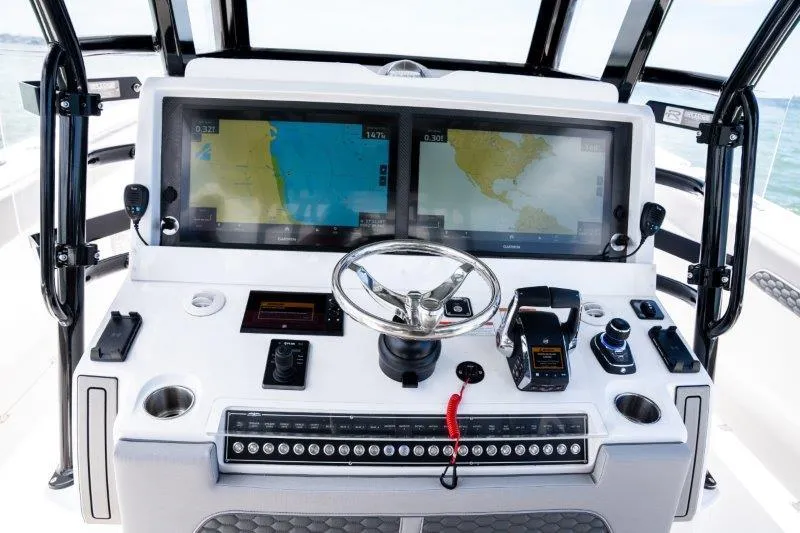  Yacht Photos Pics Helm of 2025 Invincible 46 Catamaran with dual navigation screens and modern controls.