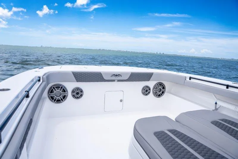  Yacht Photos Pics Invincible 46 Catamaran 2025, spacious deck with speakers, ocean view, blue sky.