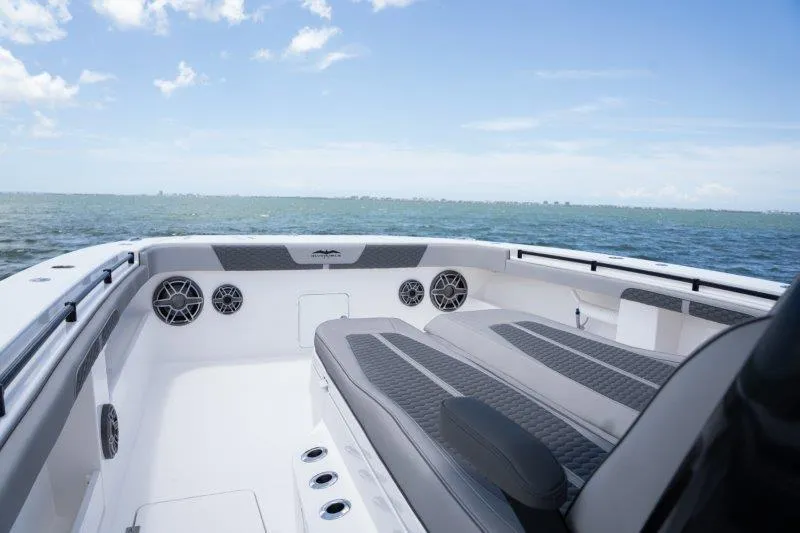  Yacht Photos Pics 2025 Invincible 46 Catamaran deck with seating, speakers, and ocean view.