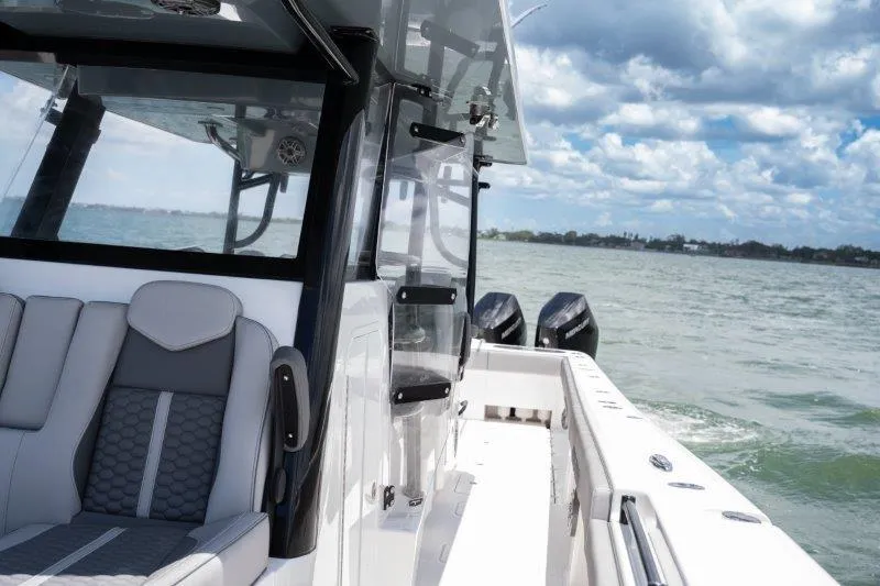  Yacht Photos Pics 2025 Invincible 46 Catamaran on water, showcasing sleek design and powerful engines.