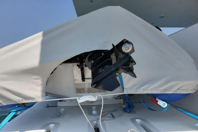  Yacht Photos Pics Covered motor on Longreach 58 boat, 2026 model, with protective tarp and ropes.