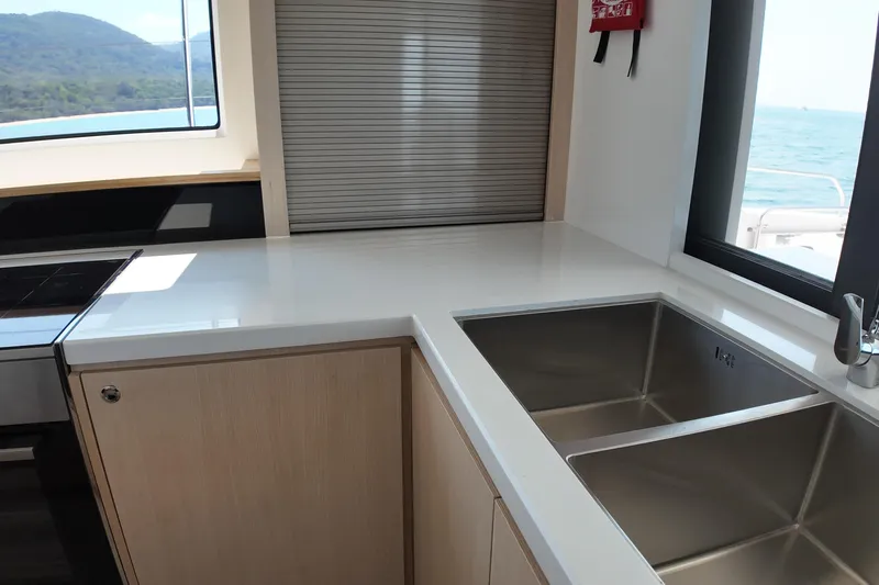  Yacht Photos Pics Modern kitchen interior on Longreach 58 yacht, featuring sleek countertops and dual sinks, 2026 model.