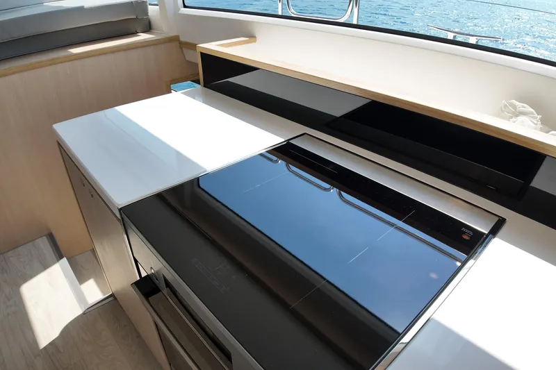  Yacht Photos Pics Modern kitchen interior on 2026 Longreach 58 yacht with sleek appliances and ocean view.