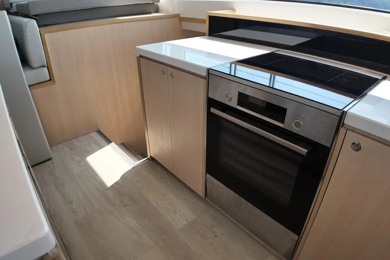  Yacht Photos Pics Modern kitchen in 2026 Longreach 58 yacht with sleek appliances and wood cabinetry.