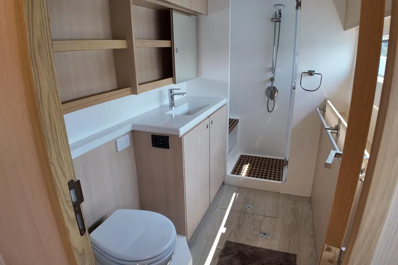  Yacht Photos Pics Modern bathroom in 2026 Longreach 58 yacht with shower, sink, and wooden accents.