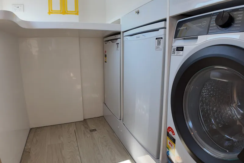  Yacht Photos Pics Modern laundry room with Longreach 58 appliances, 2026 model, featuring washer and dryer.