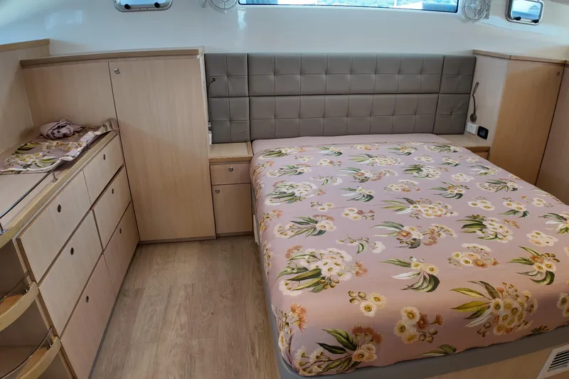  Yacht Photos Pics Luxurious Longreach 58 yacht bedroom, 2026 model, with floral bedding and modern wood cabinetry.