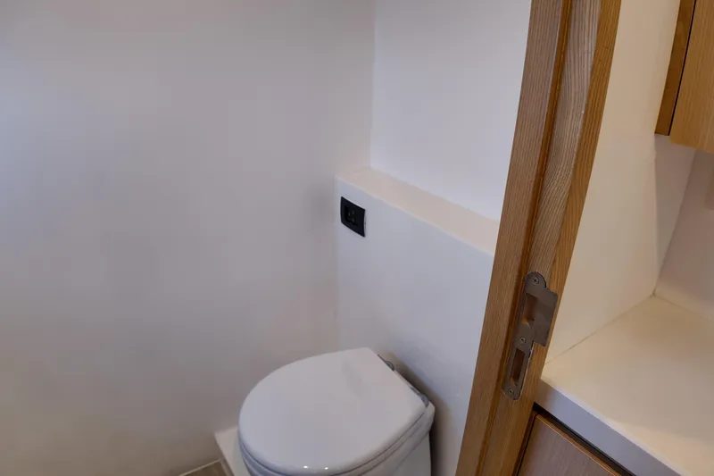  Yacht Photos Pics Modern bathroom in 2026 Longreach 58 yacht with sleek design and wooden accents.