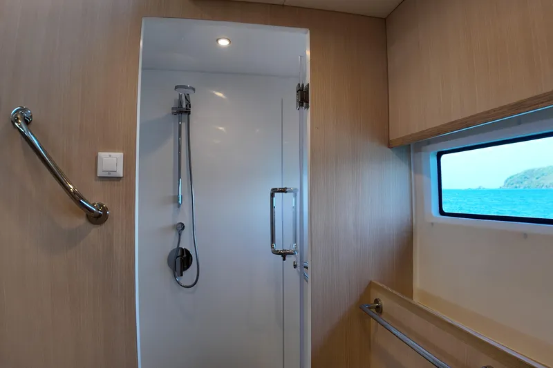  Yacht Photos Pics Modern shower area in 2026 Longreach 58 yacht with ocean view window.