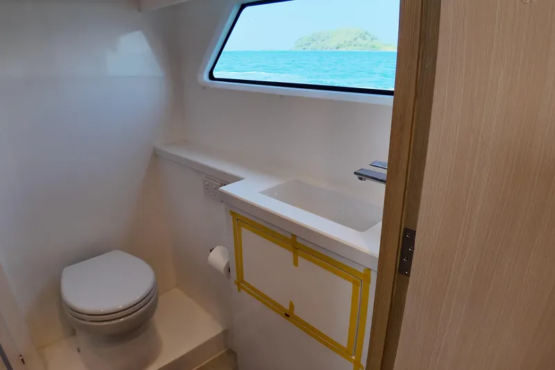 Yacht Photos Pics Compact bathroom in 2026 Longreach 58 yacht with ocean view window.