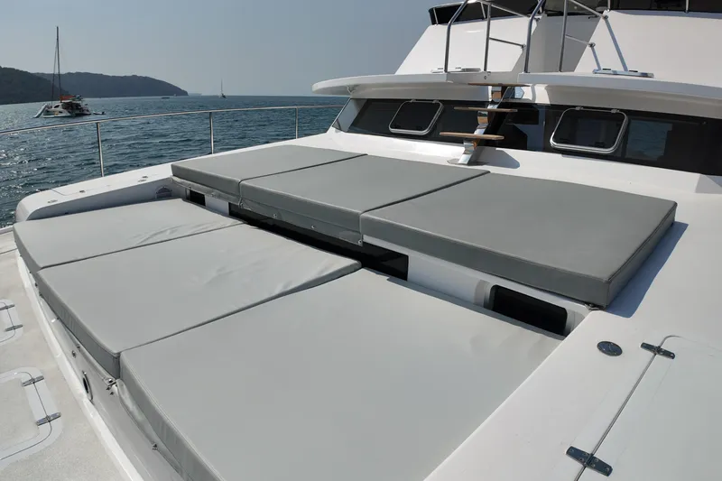  Yacht Photos Pics Luxury Longreach 58 yacht deck with cushioned seating, 2026 model, on serene ocean waters.