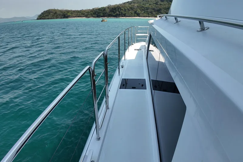  Yacht Photos Pics Sleek Longreach 58 yacht cruising near a scenic island, 2026 model.