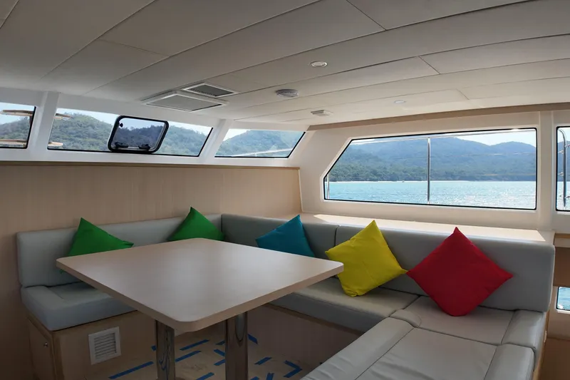  Yacht Photos Pics Modern Longreach 58 yacht interior with colorful cushions, large windows, and scenic ocean view, 2026 model.