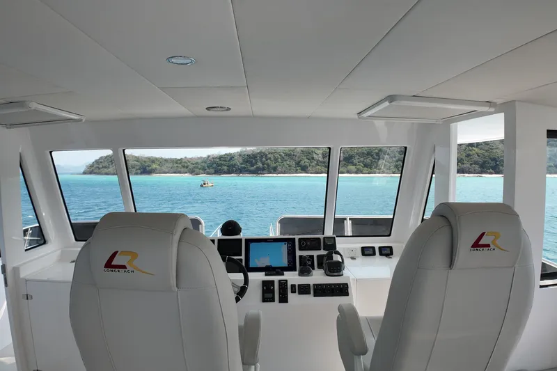  Yacht Photos Pics Interior view of 2026 Longreach 58 yacht cockpit with ocean and island scenery.