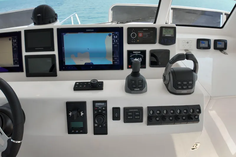  Yacht Photos Pics Control panel of 2026 Longreach 58 yacht with navigation screens and controls.
