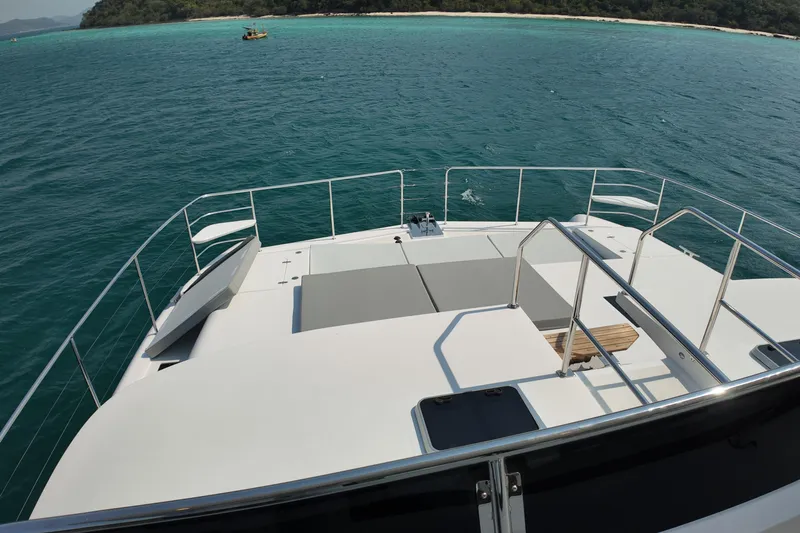  Yacht Photos Pics 2026 Longreach 58 yacht deck overlooking turquoise ocean and distant shoreline.