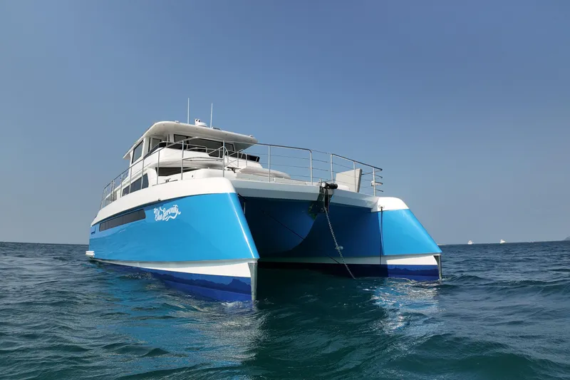  Yacht Photos Pics 2026 Longreach 58 catamaran on open sea, featuring sleek blue and white design.