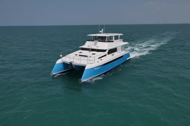  Yacht Photos Pics Longreach 58 catamaran cruising on open sea, 2026 model, blue and white design.