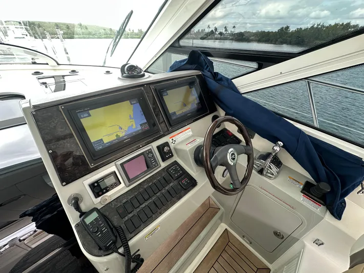  Yacht Photos Pics Cockpit of 2010 Sea Ray 470 Sundancer with navigation screens and steering wheel.