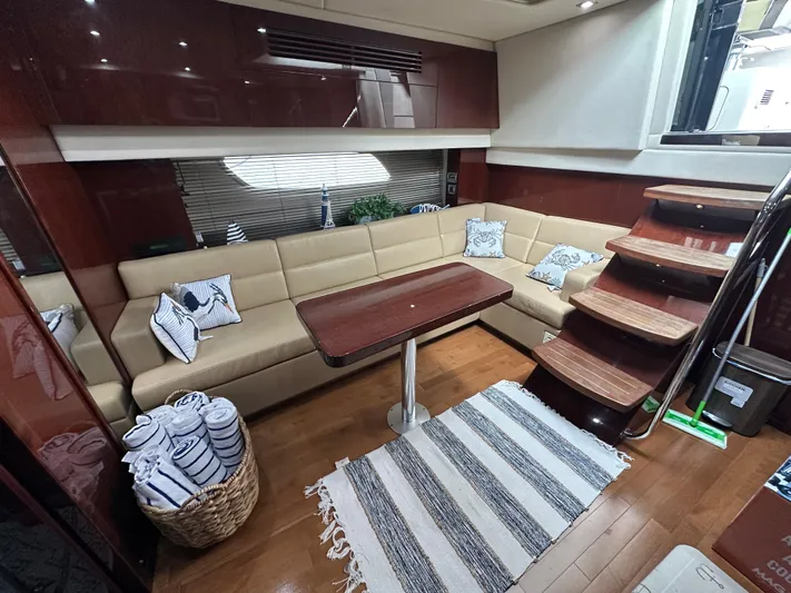  Yacht Photos Pics Luxurious interior of 2010 Sea Ray 470 Sundancer yacht with beige seating and wooden accents.