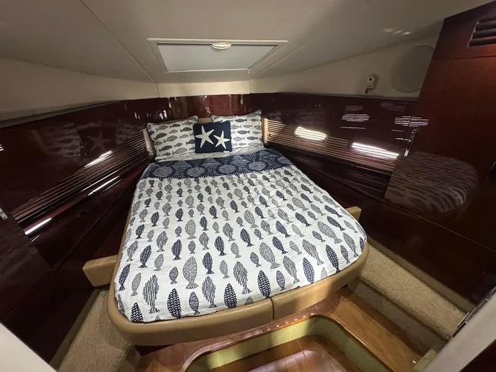  Yacht Photos Pics Luxurious cabin interior of 2010 Sea Ray 470 Sundancer with nautical-themed bedding.
