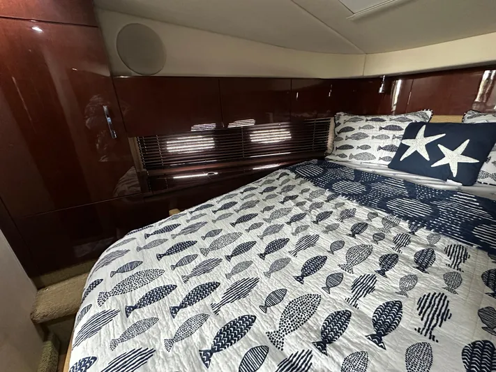 Yacht Photos Pics Luxurious cabin interior of 2010 Sea Ray 470 Sundancer with nautical-themed bedding.
